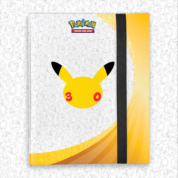 A Pokémon trading card game notebook or journal featuring Pikachu's face on the cover, with a white and yellow design, a black elastic closure band, and the Pokémon logo near the top.